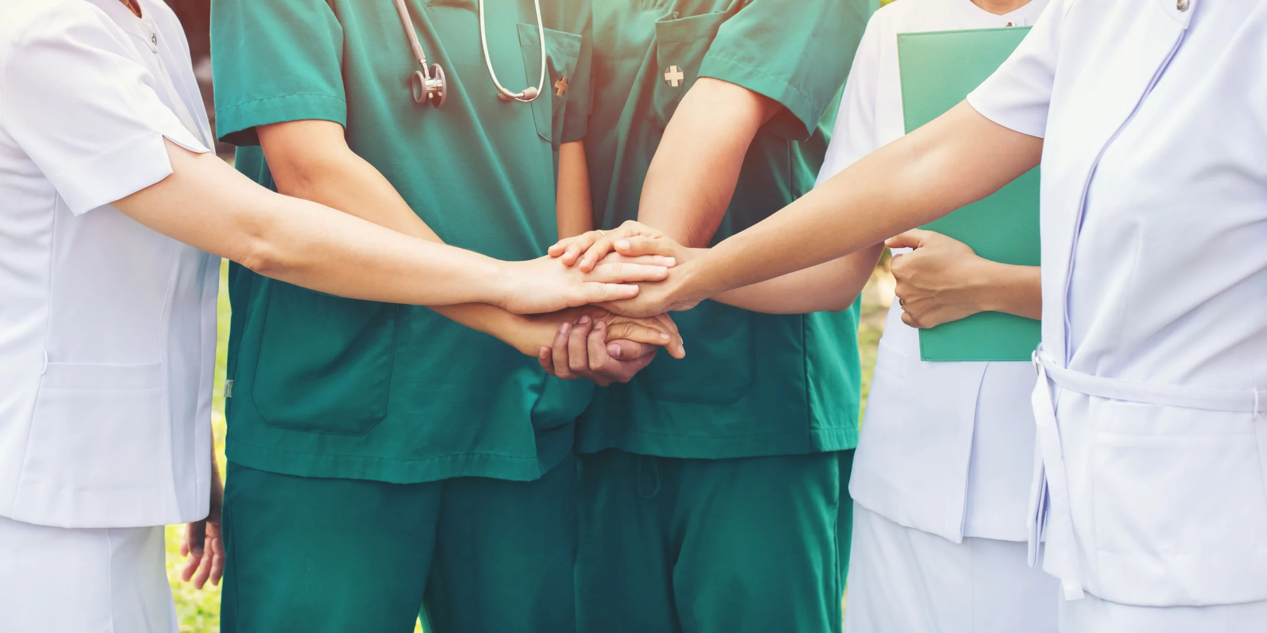 Nurses holding hands as a mark of co-operation