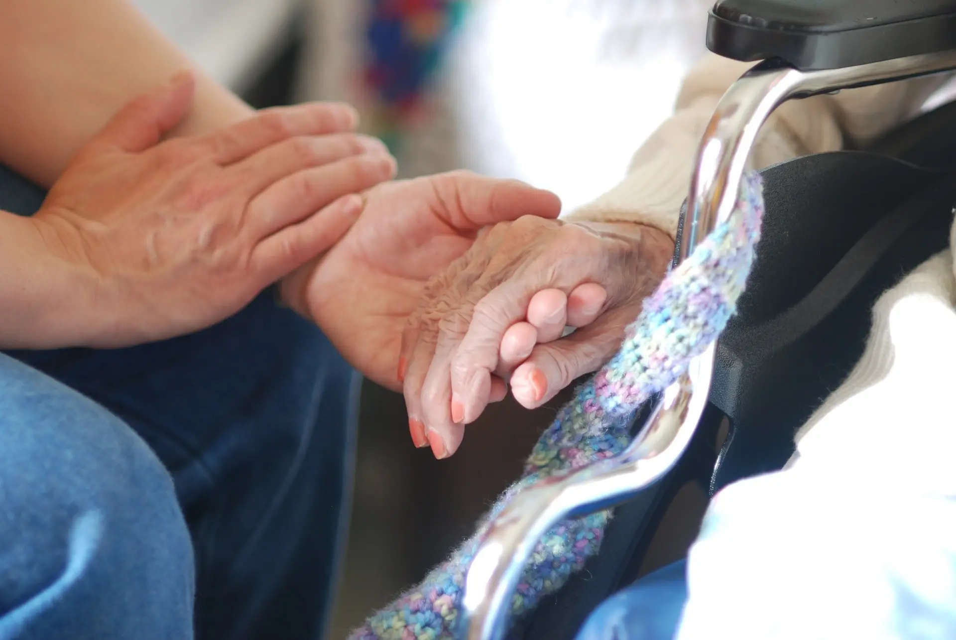 Younger person holding older person's hand