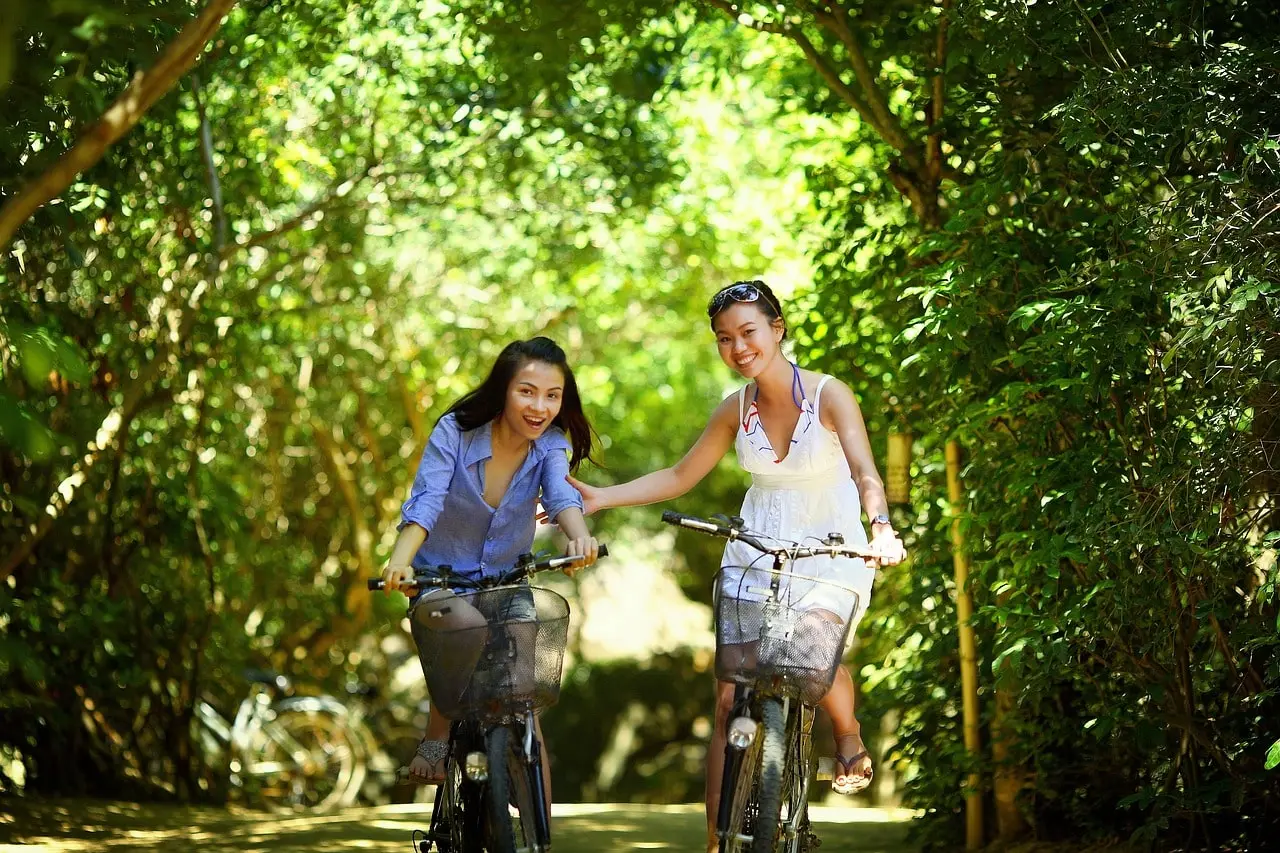 Two persons riding bikes on a forest